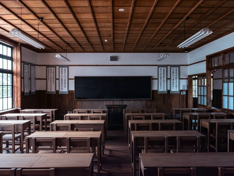 Empty school classroom with desks and a blackboard representing SEO for schools in Islamabad